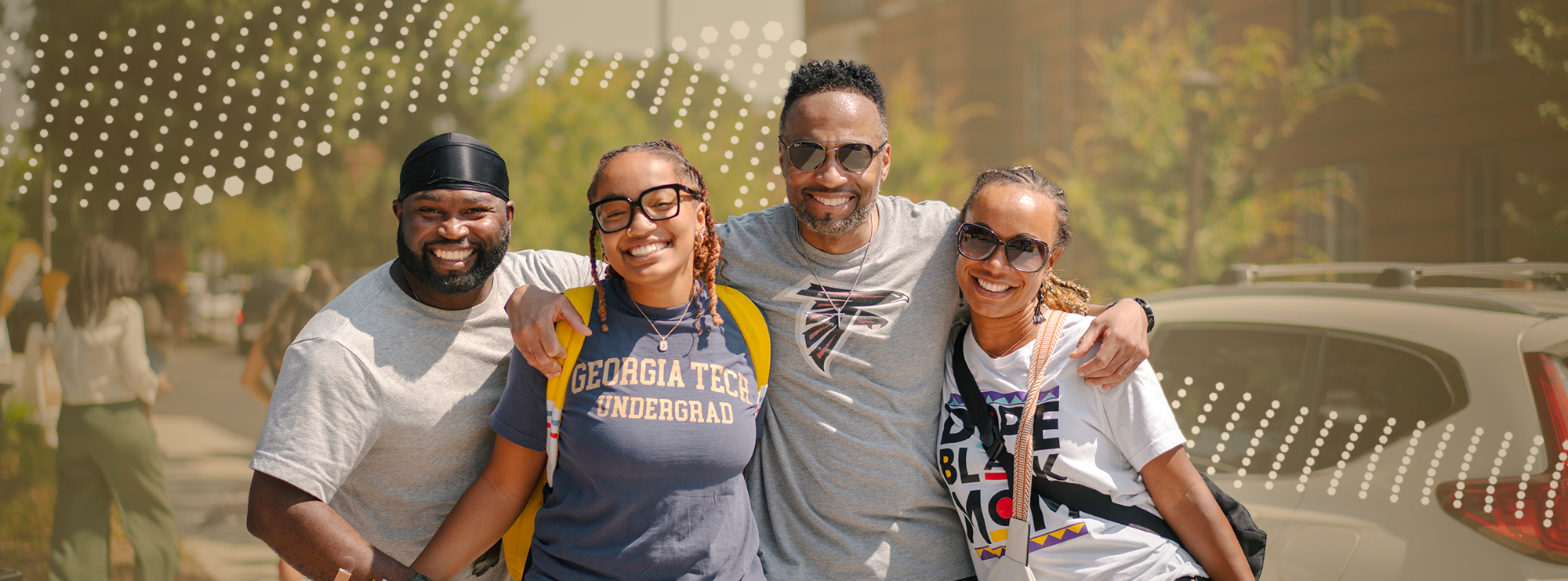 Family poses outside of Peterson Residence Hall on Move-in Day.